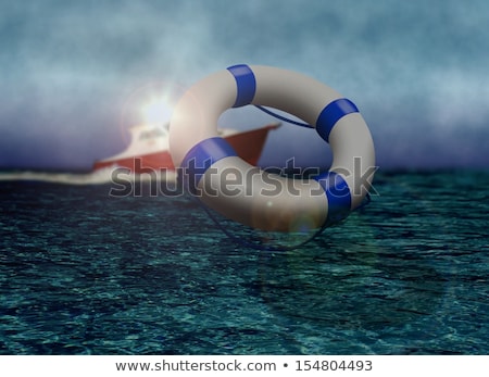 Foto stock: Rescue Boat And Life Buoy At Sea During Stormy Day