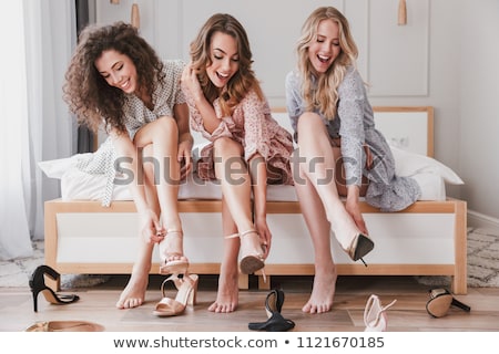 Stok fotoğraf: Picture Of Sitting Woman Trying On High Heeled Shoes