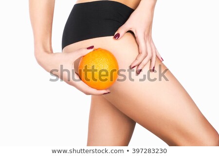 Сток-фото: Slim Female Buttocks And Orange In Hand