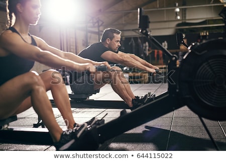 ストックフォト: Woman And Man On Rowing Machines