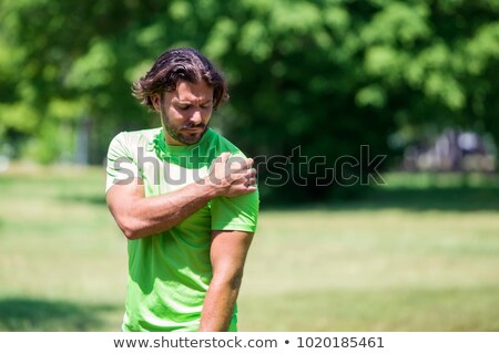 [[stock_photo]]: Runner With Shoulder Pain In Green Park