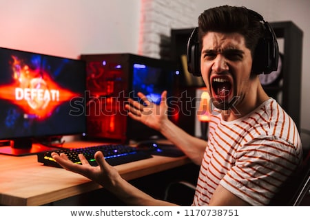 Stock fotó: Side View Of Angry Screaming Gamer Playing Video Games