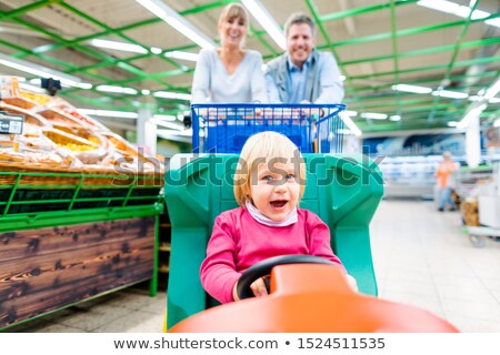 Zdjęcia stock: Couple Shopping In Supermarket Using A Special Child Trolley