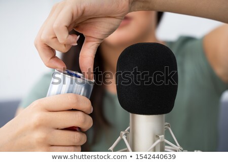 Foto d'archivio: Woman Opening Can On Microphone To Make Asmr Sounds