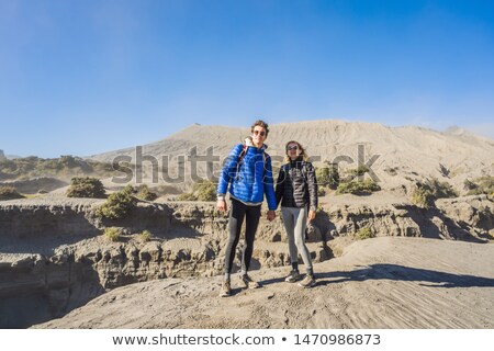 Stok fotoğraf: Young Couple Man And Woman Visit The Bromo Volcano At The Tengger Semeru National Park On Java Islan
