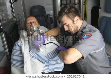 Stock photo: Professional Paramedics Giving Unconscious Men First Aid