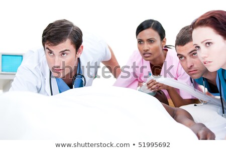 Сток-фото: Multi Ethnic Doctors Resuscitating A Senior Patient