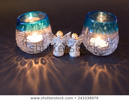 [[stock_photo]]: Two Little Angels And Reflections Of Tea Lights