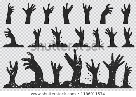 Foto d'archivio: Zombie Hands Sticking Out From The Ground Vector