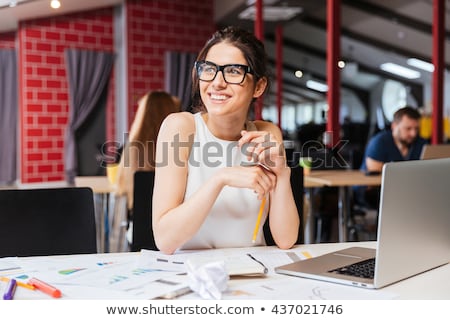 Foto stock: Woman Smiling Working At Computer