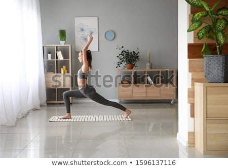 Stockfoto: Young Woman Practicing Yoga At Home