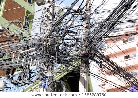 Stock fotó: Messy Wires Attached To The Electric Pole The Chaos Of Cables And Wires On An Electric Pole Concept