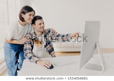 Foto stock: Affectionate Brunette Wife Supports Husband With Doing Project Work Happy Man Points Into Monitor