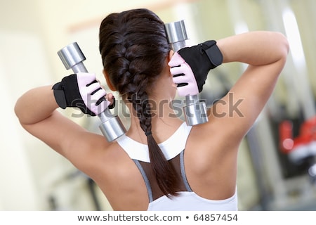 Stok fotoğraf: Back Of Young Fit Woman Holding Dumbbells On White