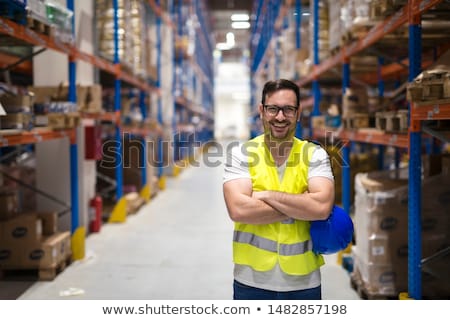 Stock photo: Warehouse Worker Standing By Forklift