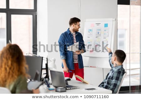 Foto stock: Creative Man Showing User Interface At Office
