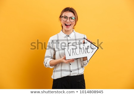 ストックフォト: Beautiful Girl Posing Isolated Over Yellow Background Holding Arrow