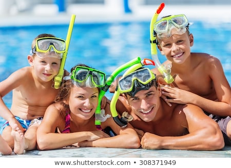 Stok fotoğraf: Dad And Son Have Fun In The Pool