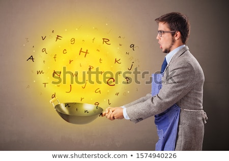 Stock photo: Person Cooking Letters In Wok