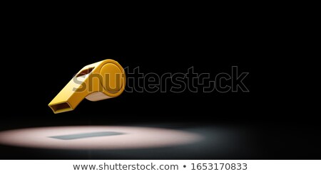 Foto stock: One Yellow Plastic Whistle Spotlighted On Black Background