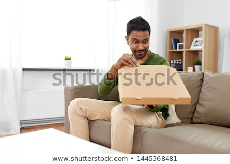 Foto stock: Indian Man Looking Inside Of Takeaway Pizza Box