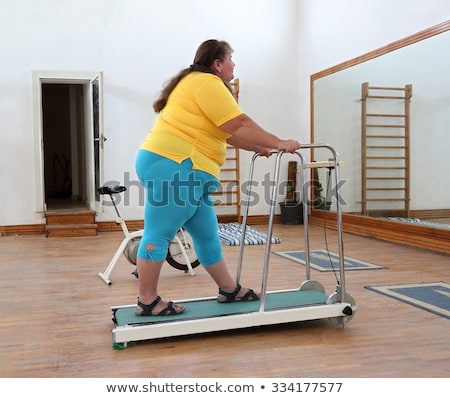 Zdjęcia stock: Overweight Woman Running On Trainer Treadmill