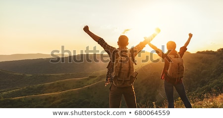 ストックフォト: Two People Sitting On Top Of A Mountain