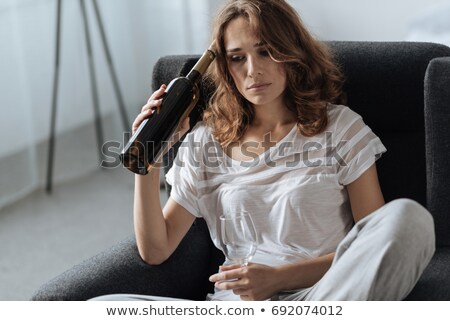 Сток-фото: Woman Drinking A Bottle Of Wine Alone