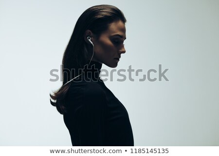 [[stock_photo]]: Side View Of Woman Listening Music