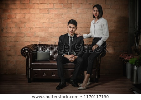 Stockfoto: Sepia Portrait Of A Beautiful Brunette On A Luxury Sofa