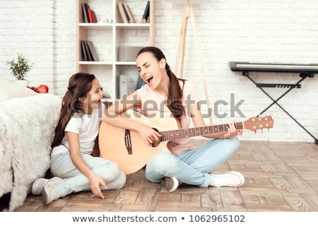 ストックフォト: Young Mom Playing Piano With Her Little Daughter