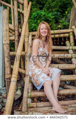 Stock fotó: Young Girl Sitting On An Old Tree On The Beach Of Boracay