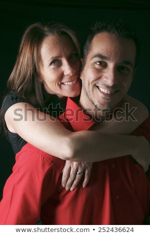 Stockfoto: A 30 Years Old Couple In Front Of Black Background