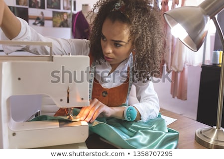 Zdjęcia stock: Front View Of Young Mixed Race Female Fashion Designer Working With Sewing Machine