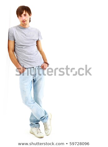 Foto stock: Man Leaning Against Studio Wall With Hands Crossed