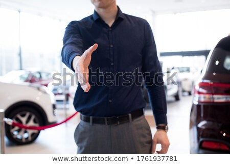 Foto stock: Midsection Of Salesman Showing Hand