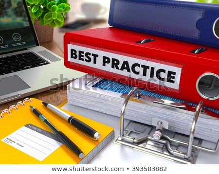 Stok fotoğraf: Red Ring Binder With Inscription Best Practice