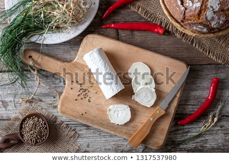 Stockfoto: Goat Cheese Pickled With Crow Garlic And Hot Peppers