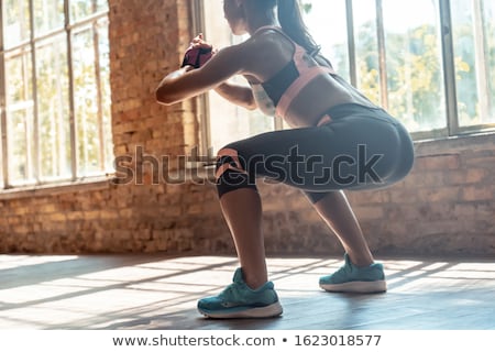 Stock photo: Adult Woman Training Legs Doing In And Out Squat