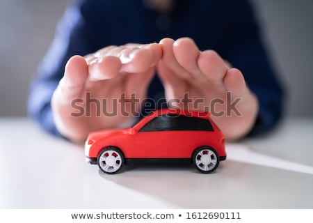 Stock fotó: Businessmans Hand Protecting Red Toy Car