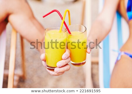 Stok fotoğraf: Couple Clinking The Glasses Of Juice On Beach