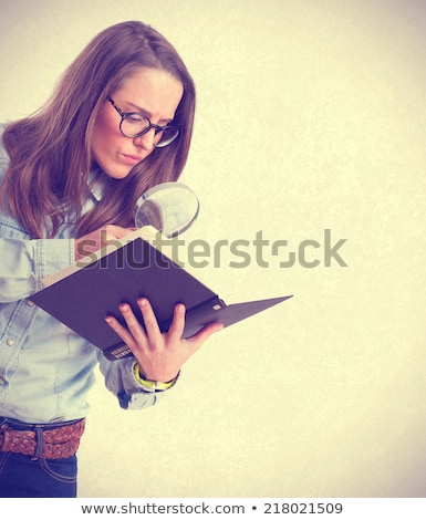 Сток-фото: Young Casual Student Looking Through Educational Literature