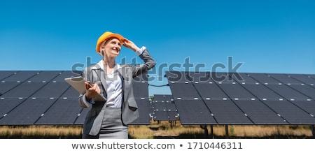 Stok fotoğraf: Business Woman Or Investor Inspecting Her Solar Farm