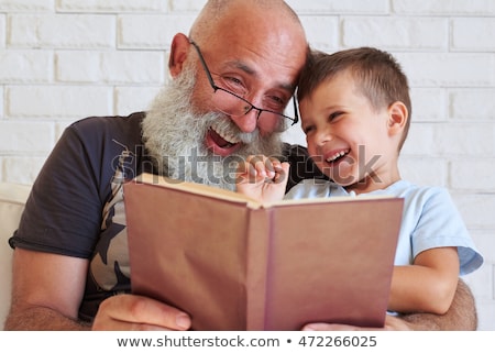 Foto stock: Grandfather Learning His Grandson To Read
