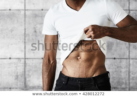 ストックフォト: Slim And Muscular Man Posing On Gray