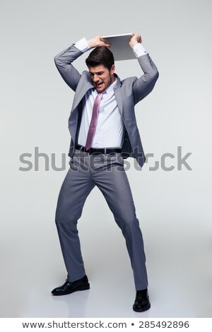 Stock photo: Business Man Tries To Destroy His Laptop