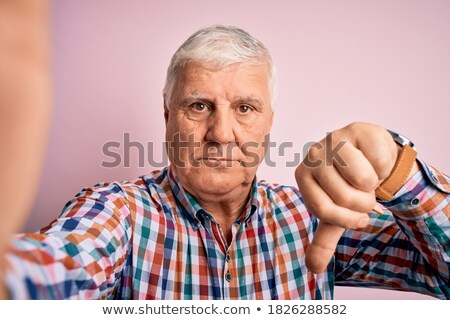 Foto stock: Senior Man Making Thumbs Down Gesture