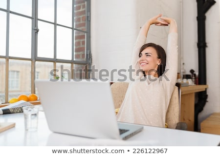 Foto stock: Woman Relaxing At Home With Her Laptop Computer