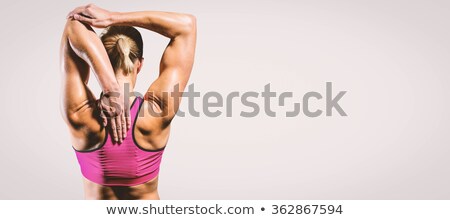 Stock photo: Composite Image Of Muscular Woman Stretching Her Arms
