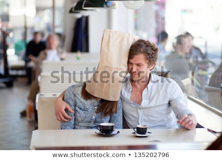 Stok fotoğraf: Happy Smiling Woman With Paper Bag On Head